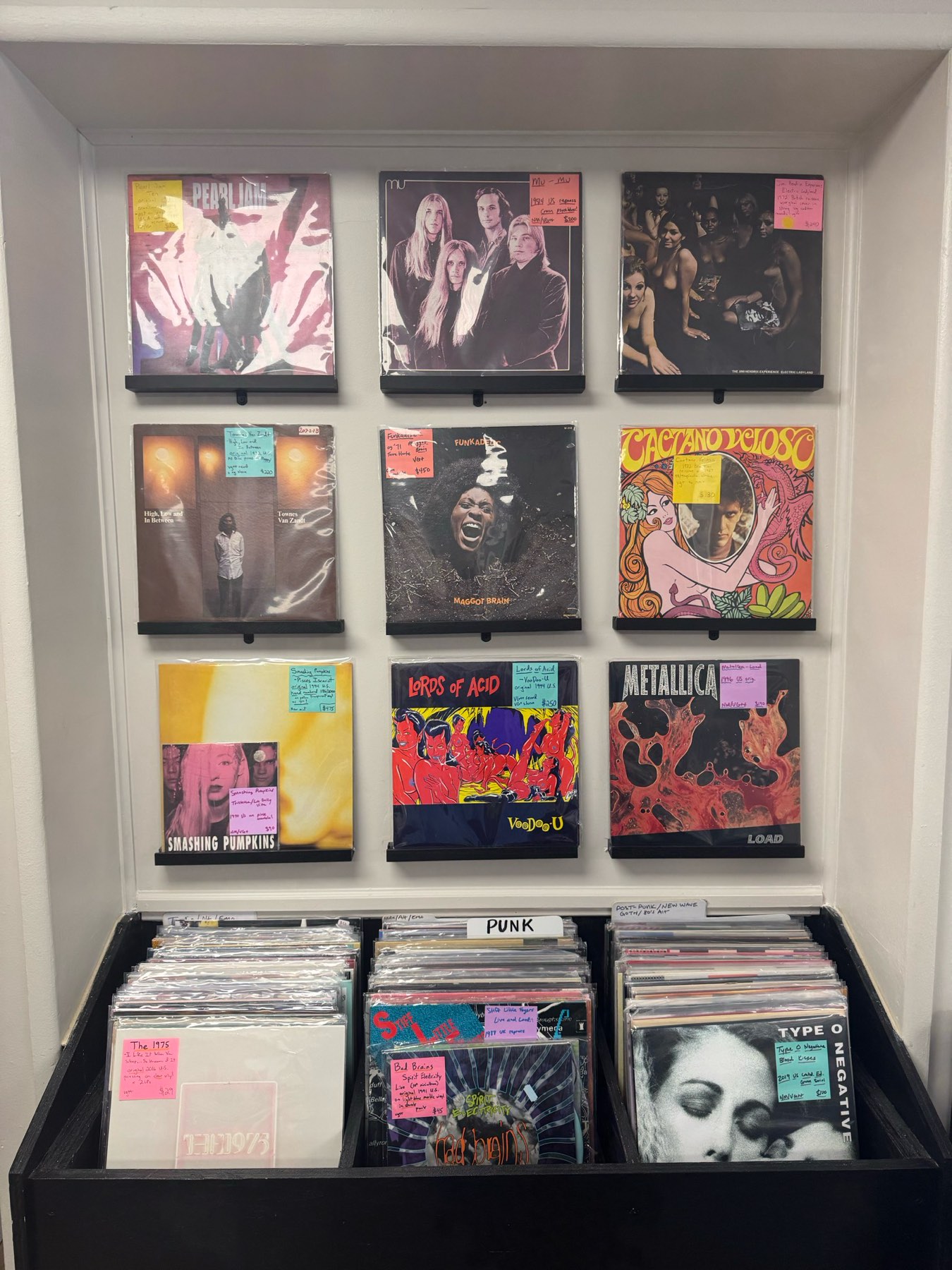 Wall display with Pearl Jam, Hendrix, Funkadelic, and bins of punk and post-punk