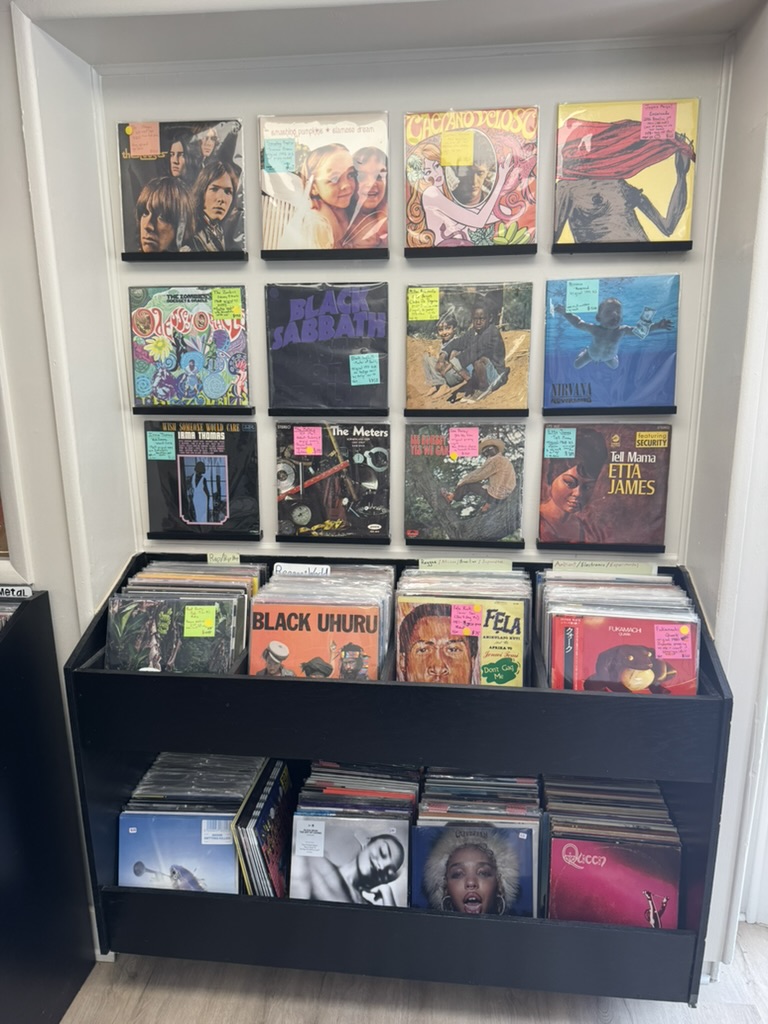 Featured records on the wall, including The Zombies, Black Sabbath, and Bill Withers